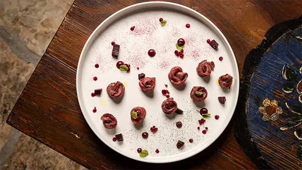 Exquisite gourmet plating at Baita Fraina restaurant in Cortina d’Ampezzo.