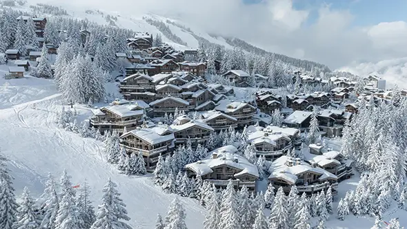 Elegant facade of Le K2 Palace in Courchevel, blanketed in fresh February snow