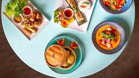 Assorted Thai dishes at Pom Thai Courchevel A variety of fine Thai cuisine dishes on a table at Pom Thai Courchevel restaurant.