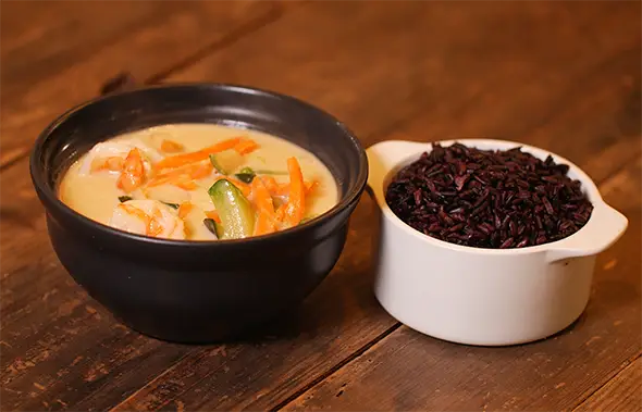 Thai curry with black rice Aromatic Thai shrimp curry with vegetables served with a side of black rice.