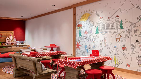 Vibrant Kids Club playroom at The Alpina Gstaad with children&rsquo;s furniture and wall coloring