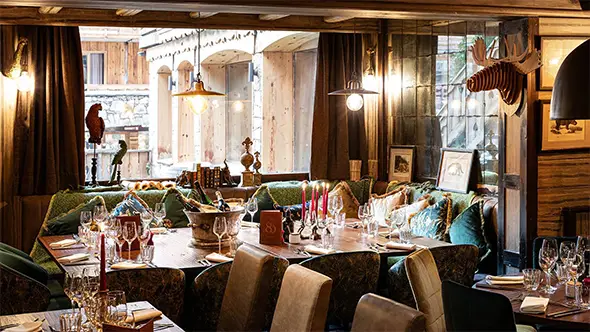 Stylish interior of Le 80 restaurant in Meribel center featuring set tables and cozy lighting