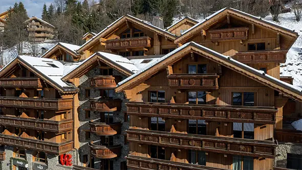Traditional wooden facade of Le Ka&iuml;la 5 hotel in the heart of Meribel