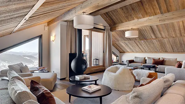 Modern living room interior in a Meribel serviced residence featuring a designer fireplace and mountain views