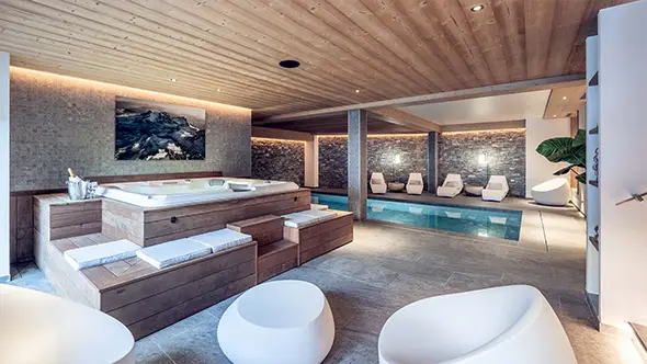 Modern SPA area interior in a premium Meribel chalet featuring a swimming pool, jacuzzi, and relaxation zone