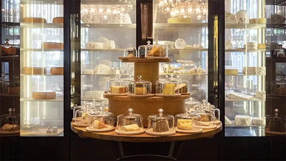 Cheese display at The Chedi Andermatt restaurant featuring local gourmet products.