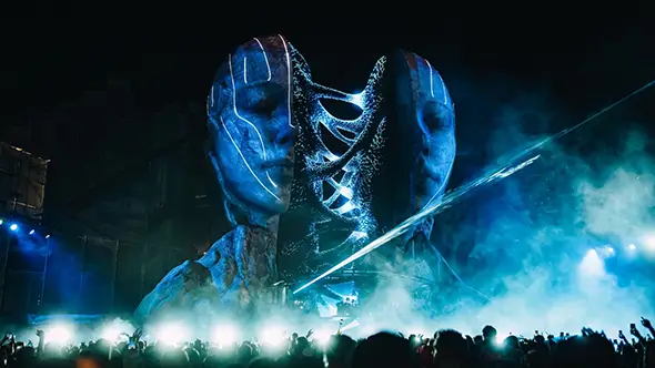 The main stage of Tomorrowland Winter festival in Alpe d Huez with giant face decorations.