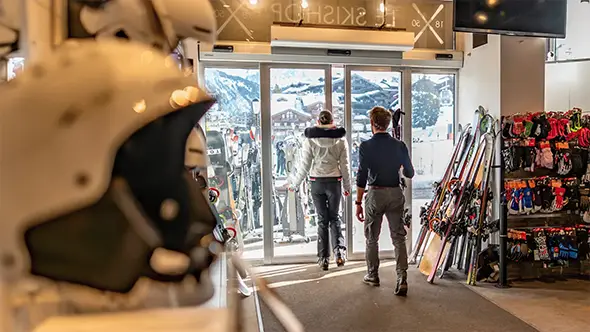 Guests exiting the ski boutique L Atelier 1850.