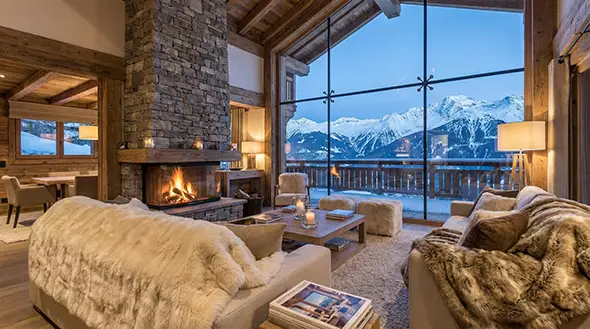 Interior of a luxury chalet in Courchevel with a fireplace.