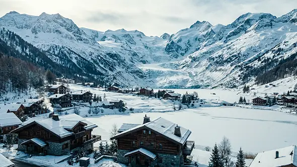 Aerial view of a Swiss ski resort and mountains.