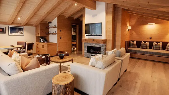 Penthouse living room with fireplace and sofas.