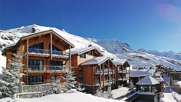 Exterior of Koh-I Nor chalets in winter snow.