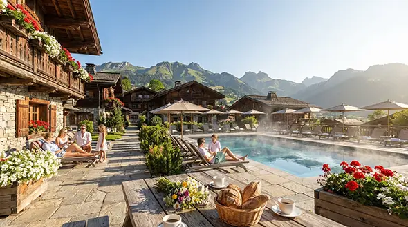 Relaxing on a sunny terrace by a warm swimming pool in the mountains.