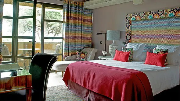 Stylish room with pink accents, Missoni fabrics, and bay views.