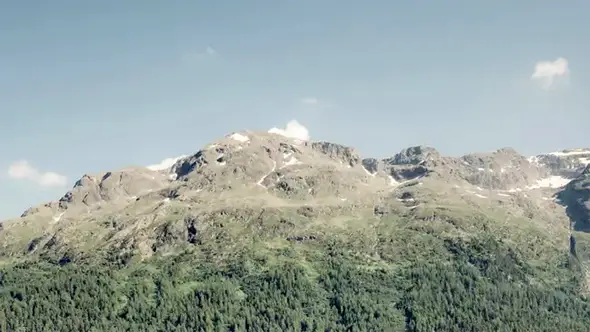 Rocky mountain peak against a clear blue sky.