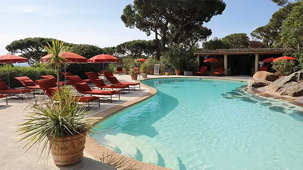 Lagoon pool carved into the rock, surrounded by century-old pines.