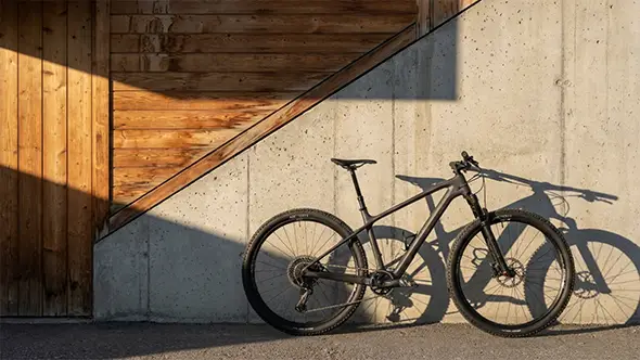 Mountain bike against a wooden and concrete wall in the Alps.