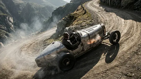 Vintage car on a sharp turn of Bernina Gran Turismo.