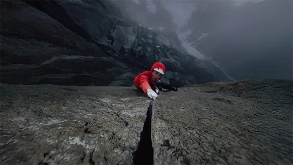 Climber tackling a steep rock crack in the mountains.
