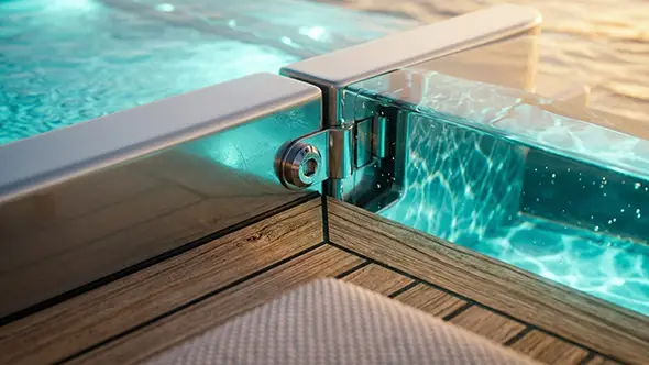 Detailed view of the glass pool edge hinge on the deck.