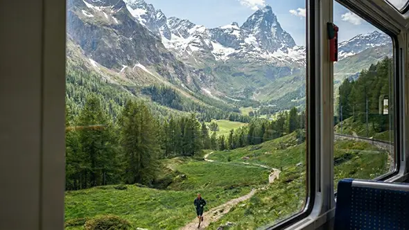 Runner on the marathon route, seen from the special train along the course in Zermatt.