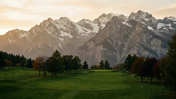 Golf course in Crans-Montana against Alpine mountains.