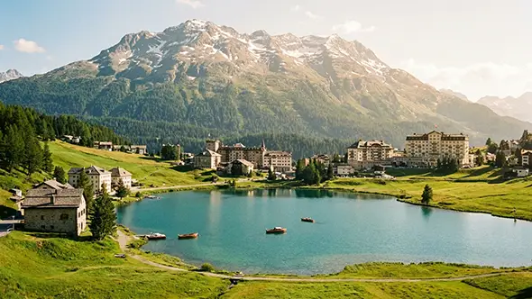 View of Lake St. Moritz and historic palace hotels in late summer.
