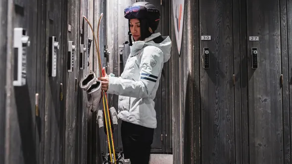 Skier at a private wooden locker in the ski room of Hôtel Mont-Blanc Chamonix