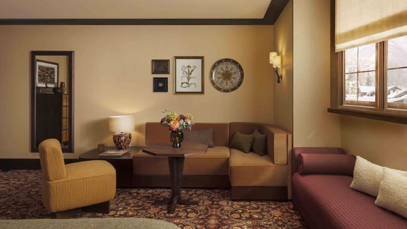 Sitting corner with banquette, framed botanical prints and a ceramic plate at Le Saint Roch Courchevel