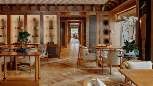 The refurbished Library at Aman Le Melezin, parquet floor and windows onto the pines