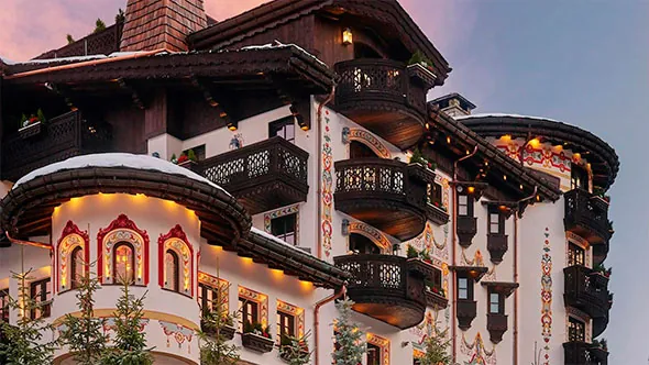 The lit facade of Les Airelles in Courchevel 1850, where three of the dinner rooms are