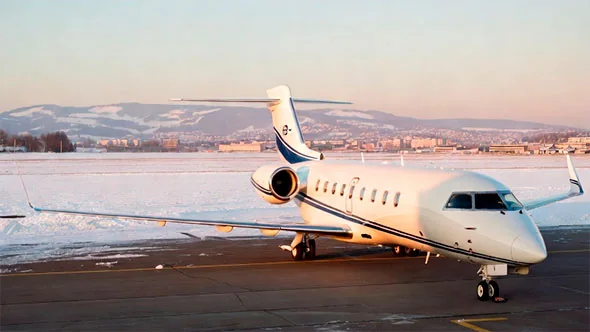 A private jet on a snowy apron at a regional airport