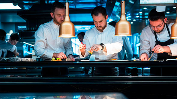 The culinary team at the two-Michelin-starred Albert 1er restaurant in Hameau Albert 1er hotel, working in the kitchen