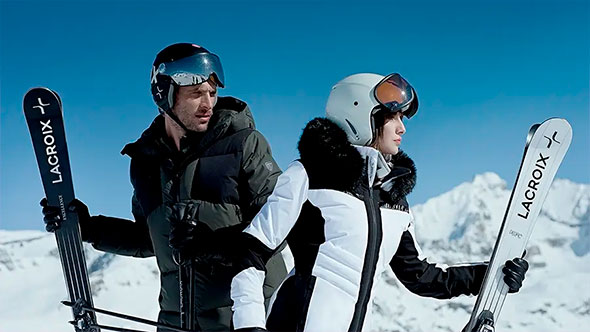 Skiers with professional Lacroix skis against the backdrop of snowy peaks in Courchevel