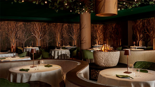 Luxury fine dining restaurant interior with a forest theme, carved wooden walls, green chairs, and a central stone fireplace in the Dolomites.
