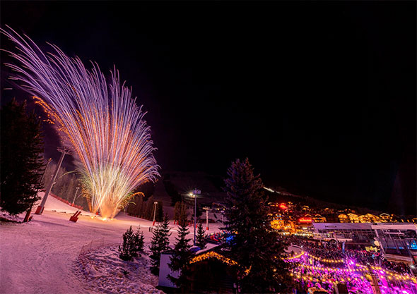 Pyrotechnic show during the International Fireworks Festival against the backdrop of the snowy Alps.