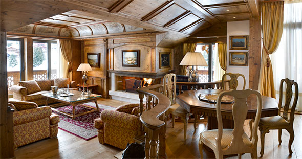 Spacious living room and kitchen interior of a modern Alpine apartment in Courchevel, illustrating family comfort.