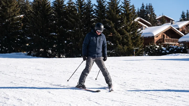 Adult beginner in a snowplough on a wide gentle piste in the French Alps