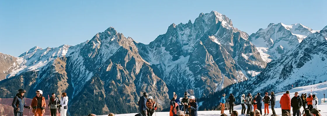 People relaxing on a sunny ski resort terrace in Meribel, Alps