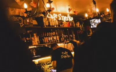 Interior of Cafe Snesko apres-ski bar with a bartender and warm lighting