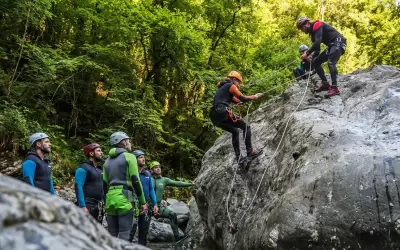 Instructor helps a group on a canyoning route.