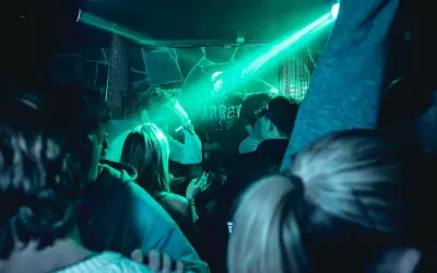 People dancing on Klub Summit nightclub dancefloor under green laser light