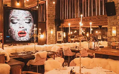 Cozy interior of the La Ferme Saint-Amour restaurant-club in Courchevel.