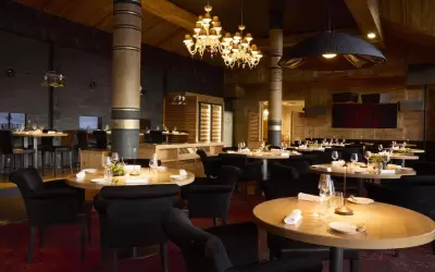 Luxurious interior of Le Diamant Noir restaurant with set round tables and chandeliers