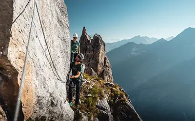 Climbers on a via ferrata route in the Courchevel mountains