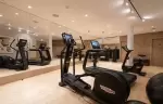 Fitness room with cardio machines and mirrored walls at Lys Martagon, Courchevel 1850