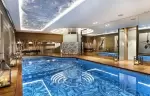 Indoor pool with a swirling mosaic floor in the spa of Lys Martagon, Courchevel 1850