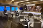 Prohibition Bar with a large oval table, armchairs and a backlit counter at Lys Martagon, Courchevel 1850