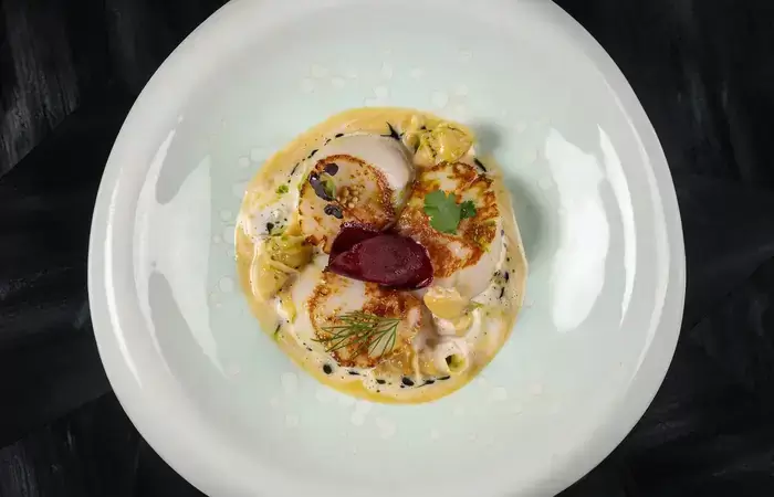 Scallops with beetroot served on a white plate at the Lys Martagon restaurant, Courchevel 1850