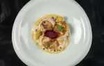 Scallops with beetroot served on a white plate at the Lys Martagon restaurant, Courchevel 1850